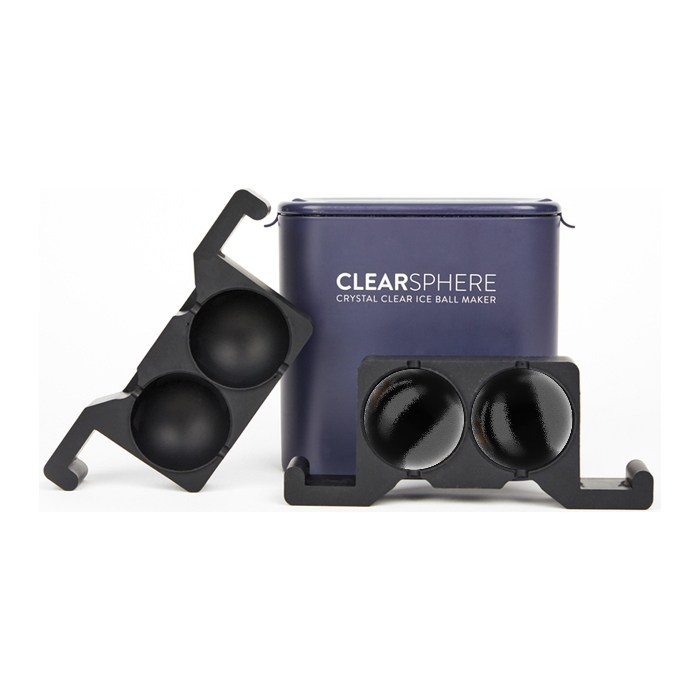 A dark blue CLEARSPHERE Crystal Clear Ice Ball Maker container with white lettering accompanied by two black plastic spherical ice molds