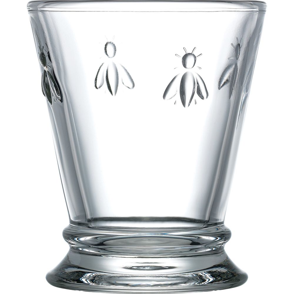 Clear glass tumbler adorned with embossed bee motifs featuring a slightly flared base with a ridged design and a smooth transparent surface
