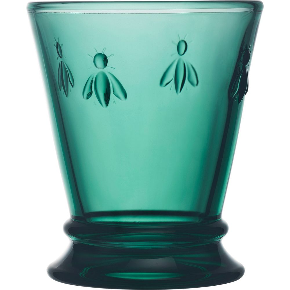 Emerald green glass drinking glass with embossed bee motifs and a flared pedestal base on a white background