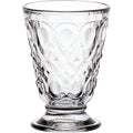 Clear glassware with ornate textured design featuring diamond and teardrop patterns on a small footed base against a white background