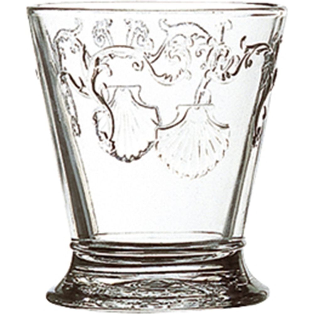 Clear glass tumbler featuring ornate embossed scallop shell motifs and swirling decorative flourishes above a textured base