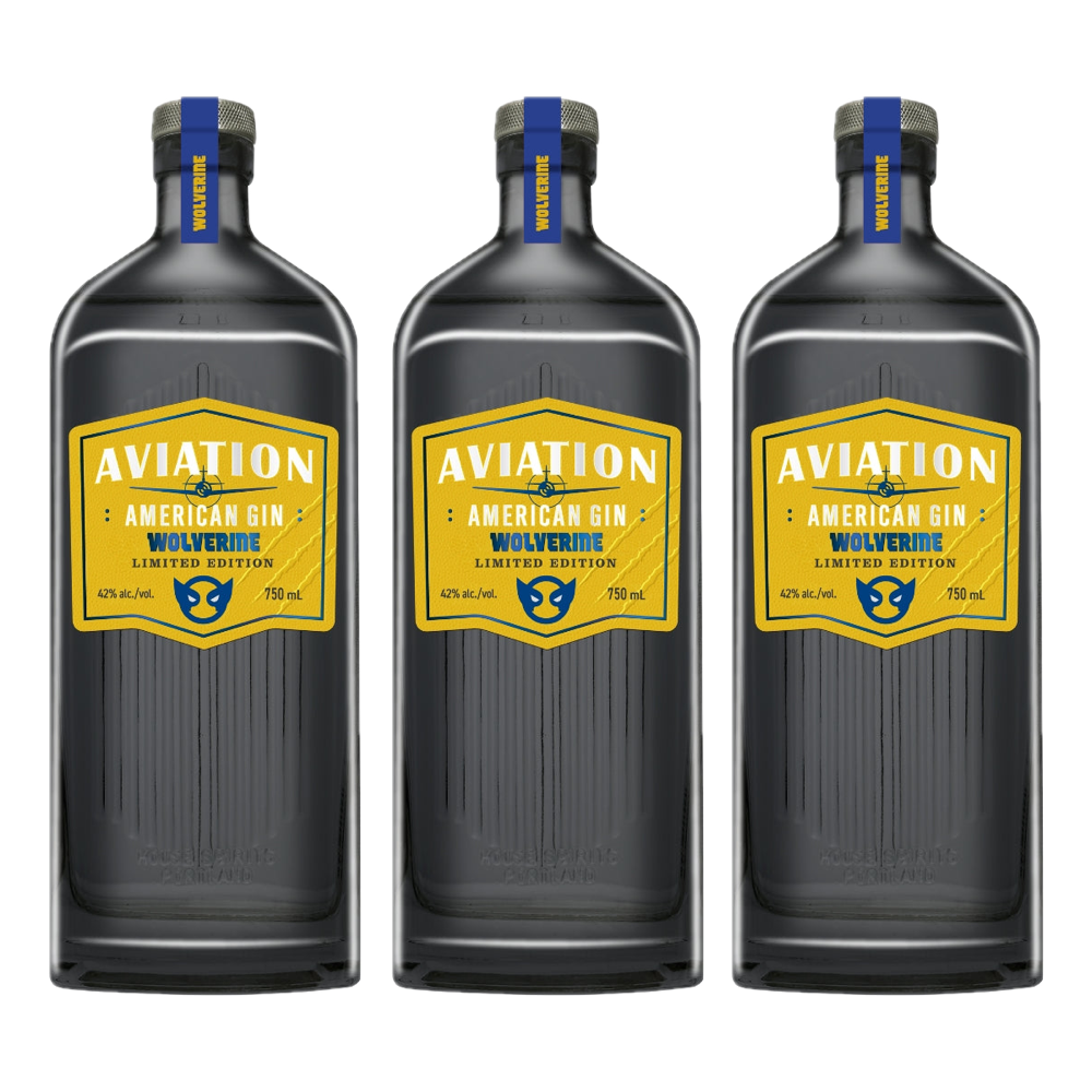 Product photography of three Aviation American Gin Wolverine Limited Edition 750 mL bottles with dark grey ribbed glass, distinctive yellow hexagonal labels displaying an airplane icon and blue Wolverine mask logo, and blue neck bands bearing the Wolverine name