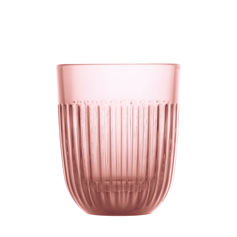 A translucent rose pink glass tumbler with a distinct vertical fluted design and a smoothly curved base