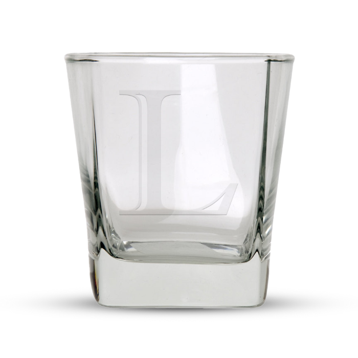 Clear glass whiskey tumbler with a square base and an etched capital L