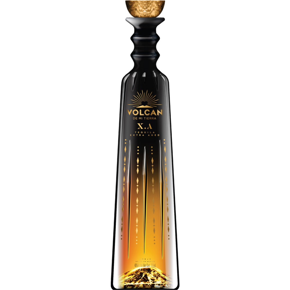 Volcan de mi Tierra X.A. Tequila Extra Aged bottle featuring a sleek black sculptural design, a prominent golden sunburst logo, elegant ascending golden flame patterns, and a shimmering golden volcanic landscape at its base topped with a textured gold stopper