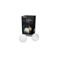 Product photography of The Original Whiskey Ball ice mold product showing its black packaging box featuring the brand logo and a whiskey glass with a spherical ice ball alongside two white silicone ice molds, one open to reveal the interior "W" brand imprint