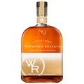 Woodford Reserve Distiller's Select Kentucky Straight Bourbon Whiskey bottle with amber liquid, featuring a festive gold and white holiday label with a sparkling dotted pattern, the 'WR' monogram, and a 'HOLIDAY' marked neck band