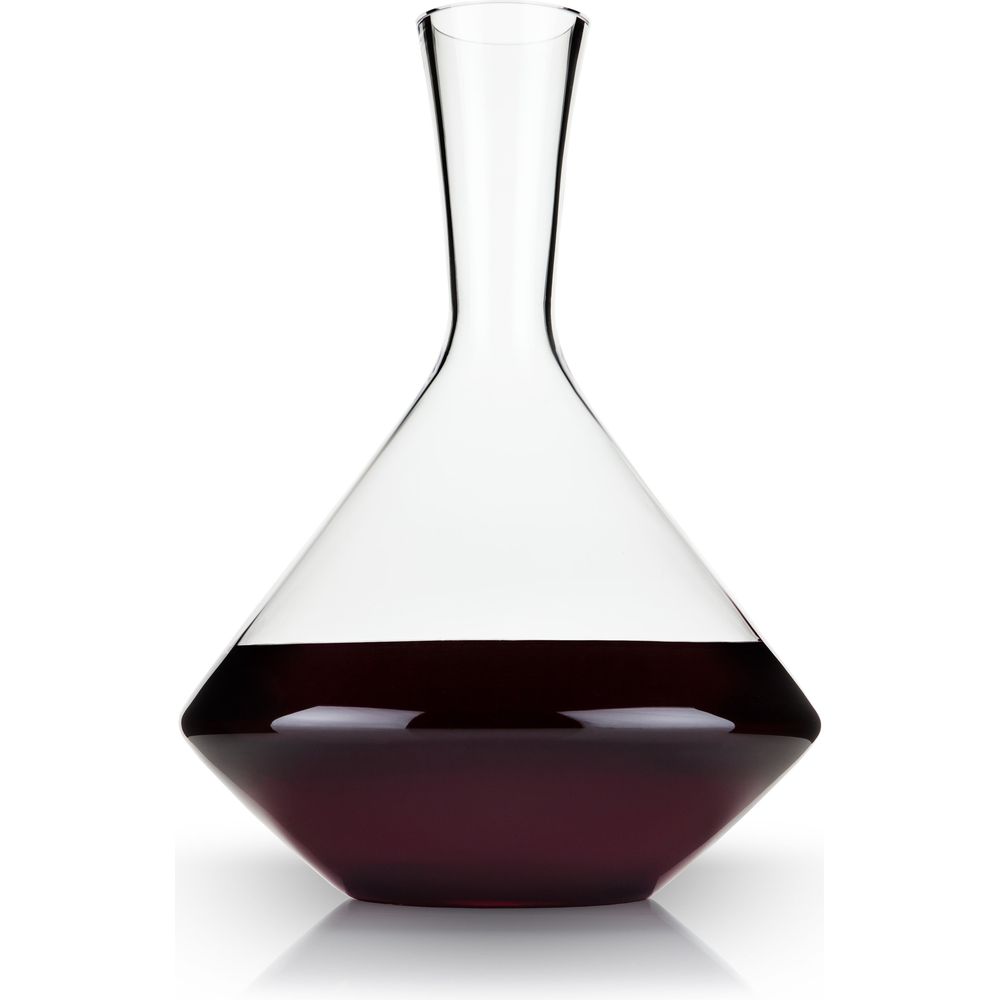 Clear glass wine decanter with a conical base and narrow neck filled with dark red wine on a white background with a subtle reflection