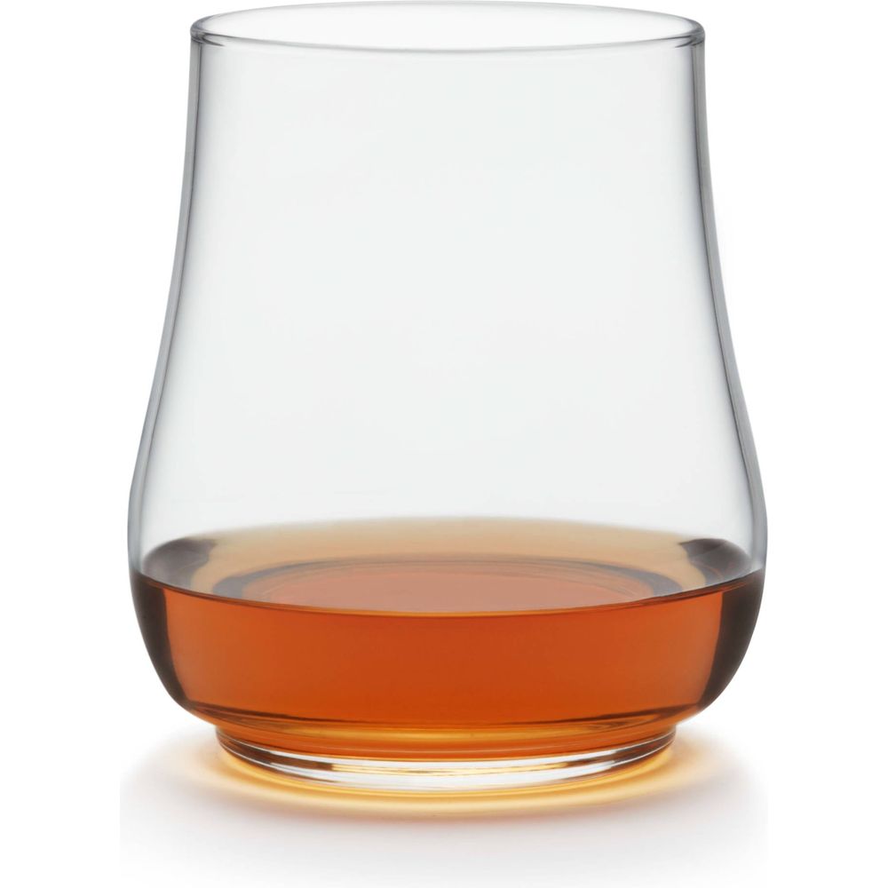Photograph of a Glencairn-style nosing glass filled with amber-colored whiskey on a crisp white background with a subtle golden glow beneath