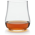 Photograph of a Glencairn-style nosing glass filled with amber-colored whiskey on a crisp white background with a subtle golden glow beneath