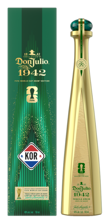 Don Julio 1942 Tequila FIFA World Cup 2026 Edition bottle and box featuring a tall, elegant golden bottle with a dark green cap and a coordinating dark green box with shimmering gold details, both prominently displaying the FIFA World Cup trophy and KOR team logos