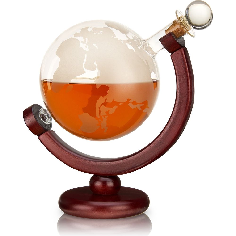 Globe-shaped glass decanter filled with amber liquid, featuring frosted world map etching, supported by a dark mahogany stand and a spherical glass stopper